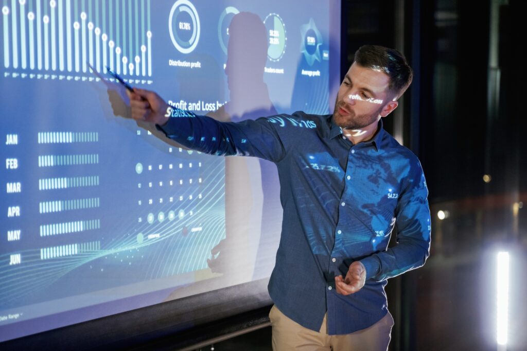 Statistics on the screen. Business coach against projector with data