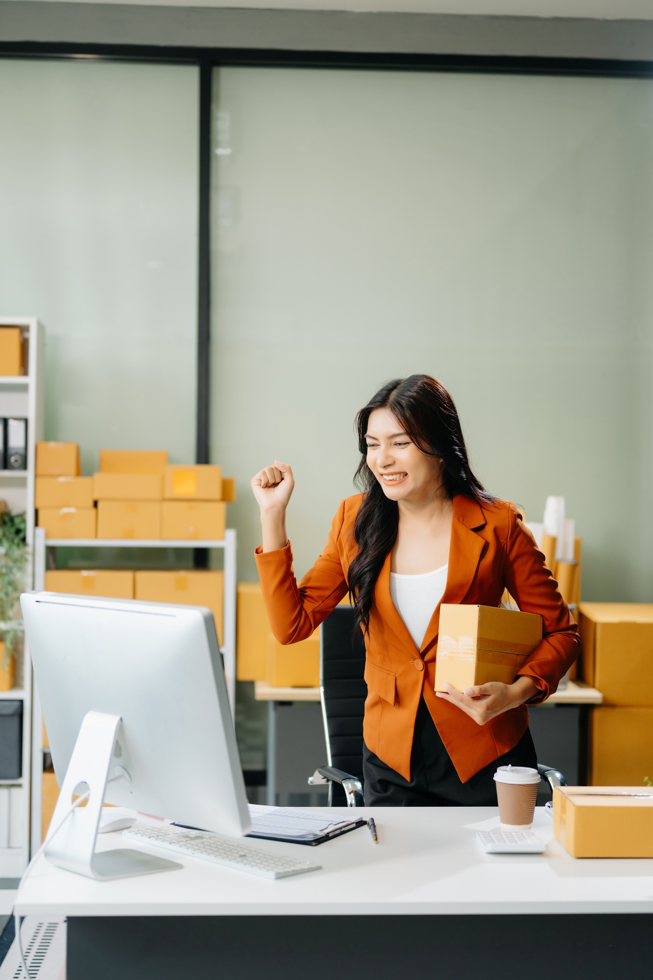 Woman Entrepreneur: SME Business mastering e-commerce with tablet, laptop, packaging,